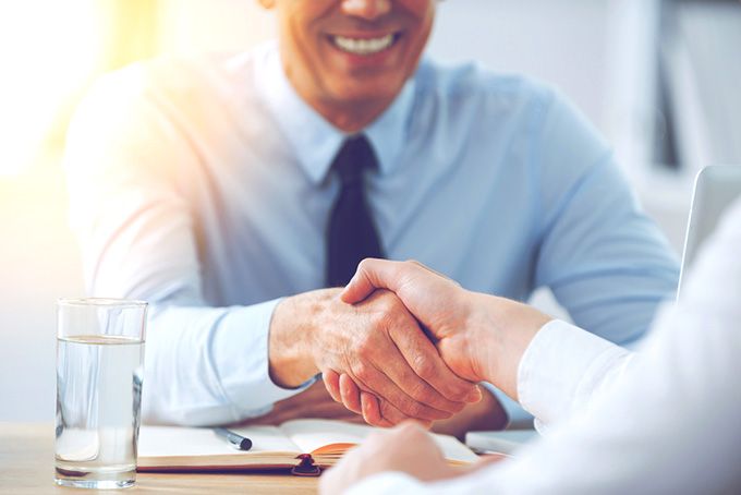 Coursera Python: men shaking hands after a successful job interview.